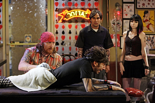 Wolowitz lays down on the table in order to get a tattoo on his butt.
